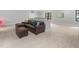 Cozy living room area with a leather sectional, neutral walls and a soft carpet at 482 Emily Ln, Chapel Hill, NC 27516