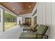 Spacious covered patio with outdoor furniture, dining area, and views of lush greenery at 482 Emily Ln, Chapel Hill, NC 27516