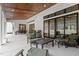 Expansive covered patio with lounge seating, dining table, and multiple access points to the backyard at 482 Emily Ln, Chapel Hill, NC 27516