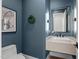 Stylish powder room features sleek floating vanity with an elegant mirror and modern fixtures at 482 Emily Ln, Chapel Hill, NC 27516