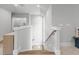 Bright staircase with wood handrail, white banisters, and light hardwood steps at 482 Emily Ln, Chapel Hill, NC 27516