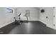 Well-equipped home gym featuring cardio machines, storage, and natural light at 482 Emily Ln, Chapel Hill, NC 27516