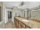 Bathroom featuring a double vanity, granite countertops, and a walk-in closet at 520 Brier Crossings Loop, Durham, NC 27703