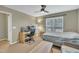 Cozy bedroom with a ceiling fan, window, and desk setup at 520 Brier Crossings Loop, Durham, NC 27703