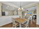 An open-concept view of the dining room, showcasing hardwood floors and a seamless transition to the living room at 520 Brier Crossings Loop, Durham, NC 27703