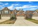 Charming townhome featuring brick and siding exterior, two-car garage, and beautifully landscaped front yard at 520 Brier Crossings Loop, Durham, NC 27703