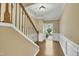 Elegant foyer with hardwood floors, staircase with ornate railing, and neutral wall colors at 520 Brier Crossings Loop, Durham, NC 27703