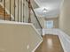 Inviting foyer showcasing hardwood floors, wainscoting detail, and staircase with decorative iron railing at 520 Brier Crossings Loop, Durham, NC 27703