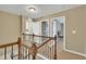 Upstairs hallway featuring views into other rooms and detailed banister at 520 Brier Crossings Loop, Durham, NC 27703