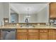 Kitchen sink with granite countertops, bronze fixtures, and mosaic backsplash, adjacent to stainless steel appliances at 520 Brier Crossings Loop, Durham, NC 27703