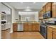 Open-concept kitchen with hardwood floors, stainless steel appliances, granite counters, and plenty of cabinet space at 520 Brier Crossings Loop, Durham, NC 27703