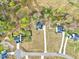 Aerial view of several homes with long driveways, surrounded by trees and a small pond nearby at 62 Narmada Ct, Zebulon, NC 27597
