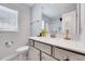 Clean bathroom featuring white countertops, modern fixtures, a vanity with gray cabinets, and a toilet at 62 Narmada Ct, Zebulon, NC 27597