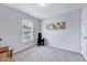 Bright, carpeted bedroom with a large window and neutral-colored walls, ideal for relaxation and comfort at 62 Narmada Ct, Zebulon, NC 27597