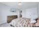 Inviting bedroom featuring a stylish dresser, mounted TV, soft neutral walls, and a large closet at 62 Narmada Ct, Zebulon, NC 27597