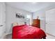 Cozy bedroom with a plush red bedspread, a window, neutral walls, and traditional wooden dresser at 62 Narmada Ct, Zebulon, NC 27597