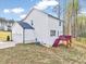 Exterior view of a white two-story home featuring a garage and small wooden deck at 62 Narmada Ct, Zebulon, NC 27597