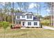 Charming two-story home with a welcoming front porch and beautifully landscaped front yard at 62 Narmada Ct, Zebulon, NC 27597