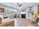 Bright living room featuring a cozy fireplace, built-in shelves, and stylish decor at 62 Narmada Ct, Zebulon, NC 27597