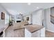 Open living and kitchen area featuring an island with countertop seating and fireplace at 62 Narmada Ct, Zebulon, NC 27597