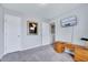 Bright room with large window, neutral walls, and carpeted floor; ideal home office space with mounted TV at 62 Narmada Ct, Zebulon, NC 27597