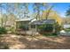 The home features a deck for outdoor enjoyment surrounded by lush greenery at 704 Emory Dr, Chapel Hill, NC 27517