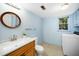 Bathroom with vanity, toilet, washer, dryer, window, and modern tile flooring at 704 Emory Dr, Chapel Hill, NC 27517