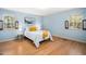 Inviting bedroom with a comfortable queen-sized bed and natural light from two windows at 704 Emory Dr, Chapel Hill, NC 27517
