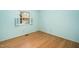 An empty bedroom with hardwood floors is illuminated by natural light from the window at 704 Emory Dr, Chapel Hill, NC 27517