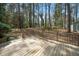 Inviting deck featuring wooden railing, ideal for relaxing and enjoying the surrounding wooded landscape at 704 Emory Dr, Chapel Hill, NC 27517