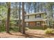 Inviting brick home featuring a mix of siding and brick facade with mature trees and landscaping at 704 Emory Dr, Chapel Hill, NC 27517