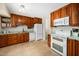 Traditional-style kitchen with wood cabinets, white appliances, and a functional layout at 704 Emory Dr, Chapel Hill, NC 27517