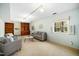 Bright living room with neutral walls, hardwood bookcases, and ample windows and natural light at 704 Emory Dr, Chapel Hill, NC 27517