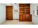 Living room with built-in wooden bookcases and a door leading to the exterior at 704 Emory Dr, Chapel Hill, NC 27517