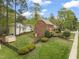 Aerial view of the house, shed, and a well-maintained lawn enclosed with a black fence at 8000 Old Deer Trl, Raleigh, NC 27615
