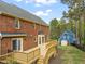 Brick home featuring a spacious wooden deck and fenced in yard at 8000 Old Deer Trl, Raleigh, NC 27615