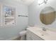 Updated bathroom with a vanity, toilet, and window at 8000 Old Deer Trl, Raleigh, NC 27615