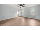 Spacious bedroom with wood-look flooring and a ceiling fan at 8000 Old Deer Trl, Raleigh, NC 27615