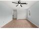 Bright bedroom with light blue walls, ceiling fan, and wood-look laminate flooring at 8000 Old Deer Trl, Raleigh, NC 27615