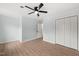 Light-filled bedroom with wood-look floors and a ceiling fan at 8000 Old Deer Trl, Raleigh, NC 27615