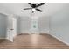 Bright bedroom featuring light blue walls, a ceiling fan, and two large closets at 8000 Old Deer Trl, Raleigh, NC 27615