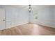 Empty bedroom with hardwood floors, a modern light fixture and fresh paint at 8000 Old Deer Trl, Raleigh, NC 27615