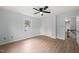This is a bedroom featuring light blue walls, wood look flooring, and a window at 8000 Old Deer Trl, Raleigh, NC 27615
