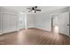 Light-filled bedroom with wood-look flooring, a ceiling fan, and dual closets at 8000 Old Deer Trl, Raleigh, NC 27615