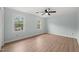 Spacious bedroom with wood-look flooring and bright windows at 8000 Old Deer Trl, Raleigh, NC 27615