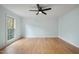 Empty bedroom with hardwood floors, light blue walls, and a ceiling fan at 8000 Old Deer Trl, Raleigh, NC 27615