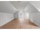 Spacious bonus room features wood-look flooring and angled ceilings at 8000 Old Deer Trl, Raleigh, NC 27615