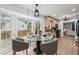 Bright eat-in kitchen nook with large windows, modern table set, and lovely backyard views for casual dining at 8000 Old Deer Trl, Raleigh, NC 27615