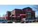 Chick-fil-A with outdoor seating and red umbrellas at 8000 Old Deer Trl, Raleigh, NC 27615
