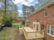 Wooden deck overlooking landscaped yard in backyard at 8000 Old Deer Trl, Raleigh, NC 27615
